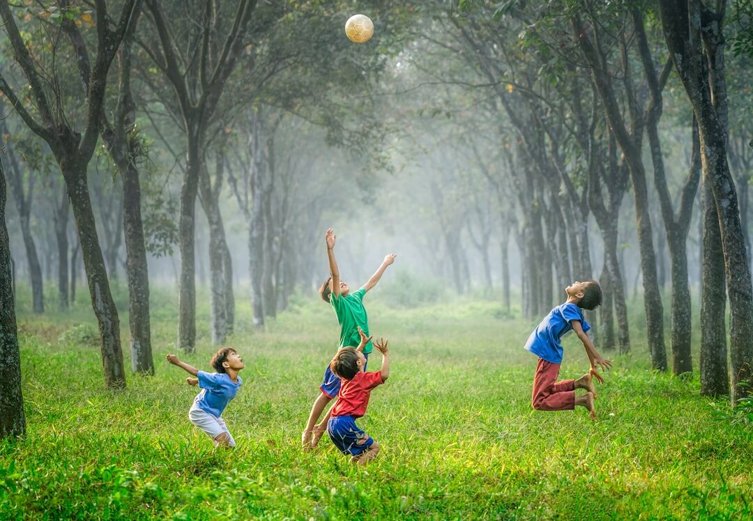 Group of children playing football on a residential street in Denmark