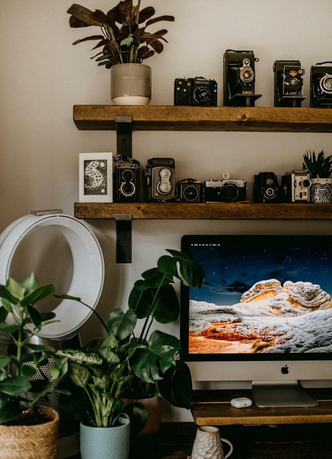 Camera and photography equipment on a wooden desk